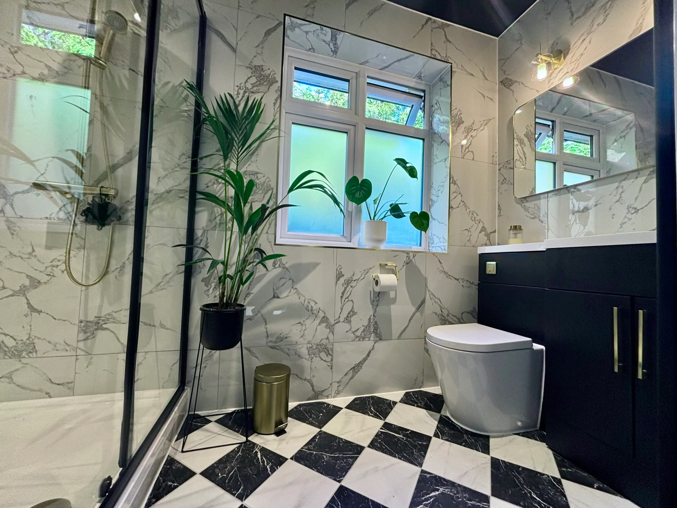 Modern bathroom with sleek fixtures, a walk-in shower, and stylish tiling.